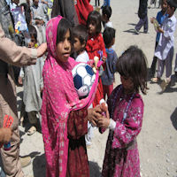 Giving to the children - they are glad to see the coalition forces